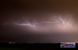 lightning strikes against purple stormy sky