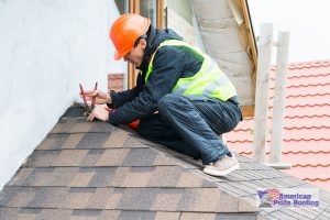 roofer installing shingles on a roof