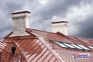 red standing seam metal roof with rain on it